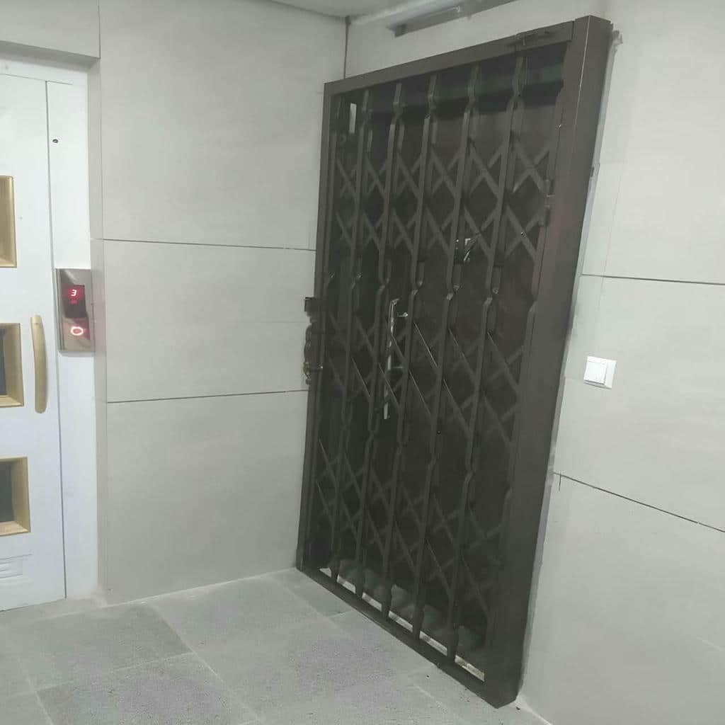 حفاظ درب آکاردئونی جمع شده کنار چارچوب